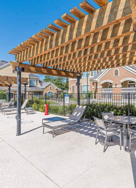 a patio with a table and chairs under a canopy at Woodway Village, Austin