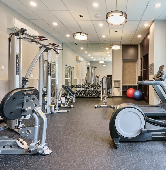 a gym with weights and other exercise equipment on the floor