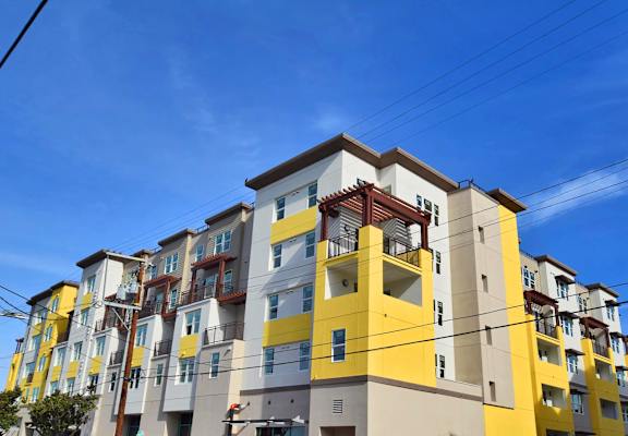 a colorful apartment building with power lines in front of it