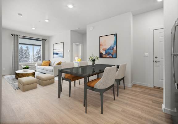 a living room and dining room with a table and chairs