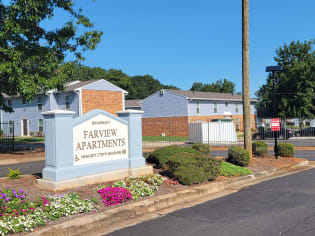 an exterior view of a property with a sign apartments