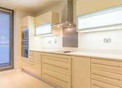 Thumbnail 2 of 3 - a large white kitchen with a stove and a window