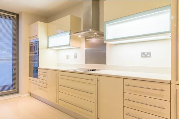 a large white kitchen with a stove and a window