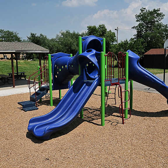 A blue and green slide in a playground.