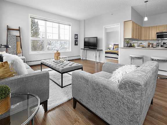 a living room with two couches and a glass table
