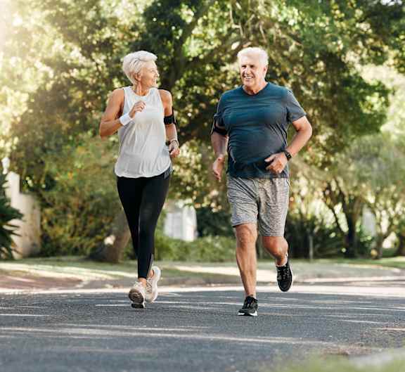 Two people jogging on a road.