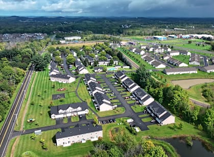 an aerial view of a neighborhood with houses and a highway