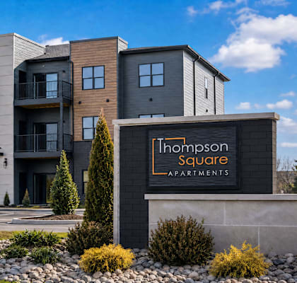 A modern apartment complex named Thompson Square is shown in the image.