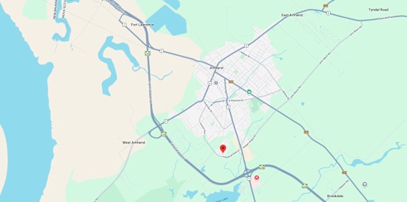 A map shows a red marker at the center of a parking lot, with various other locations and roads labeled around it.