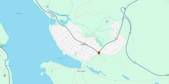 A map shows a red marker at the center of a parking lot, with various other locations and roads labeled around it.
