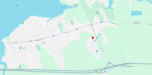 A map shows a red marker at the center of a parking lot, with various other locations and roads labeled around it.