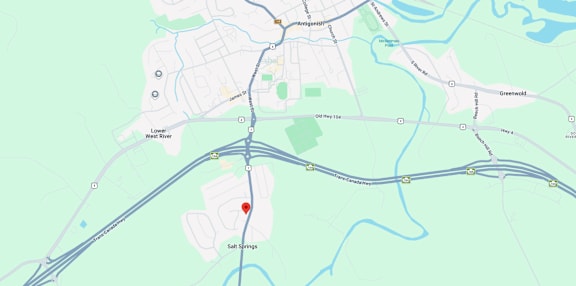A map shows a red marker at the center of a parking lot, with various other locations and roads labeled around it.