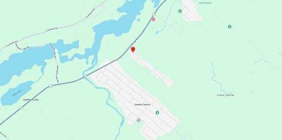 A map shows a red marker at the center of a parking lot, with various other locations and roads labeled around it.