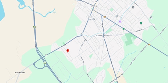 A map shows a red marker at the center of a parking lot, with various other locations and roads labeled around it.