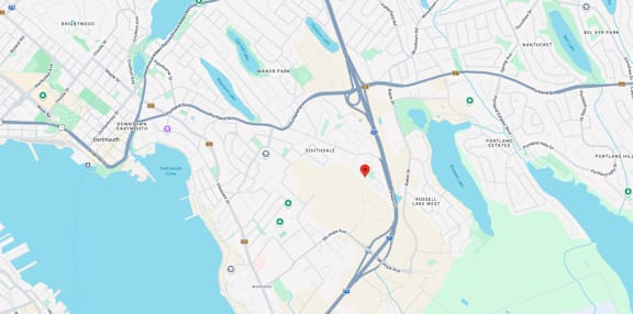 A map shows a red marker at the center of a parking lot, with various other locations and roads labeled around it.