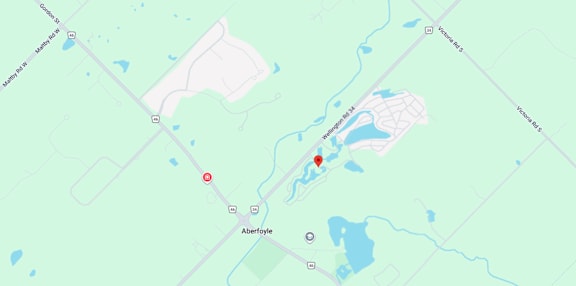 A map shows a red marker at the center of a parking lot, with various other locations and roads labeled around it.