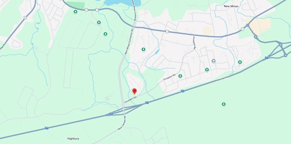 A map shows a red marker at the center of a parking lot, with various other locations and roads labeled around it.