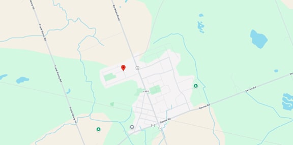 A map shows a red marker at the center of a parking lot, with various other locations and roads labeled around it.