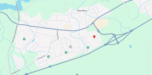 A map shows a red marker at the center of a parking lot, with various other locations and roads labeled around it.