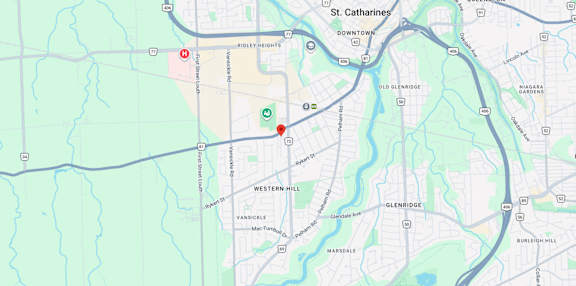 A map shows a red marker at the center of a parking lot, with various other locations and roads labeled around it.