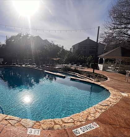 A pool with a "No Diving" sign at the edge.