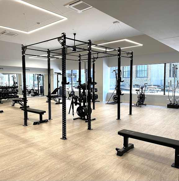 A gym with a variety of equipment including weightlifting machines and benches at 7 West 7th Apartments, Cincinnati, 45202