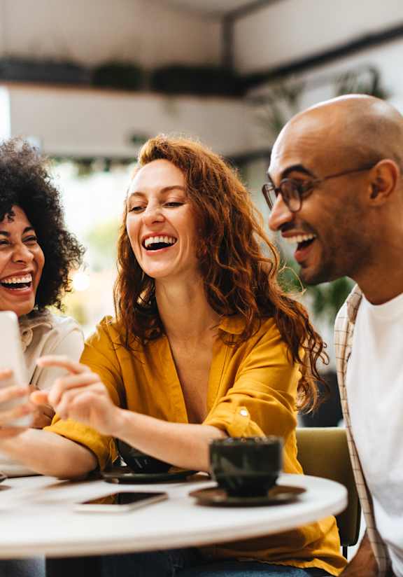people sitting at a table drinking coffee