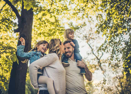 A family of four is enjoying a day out in the park.