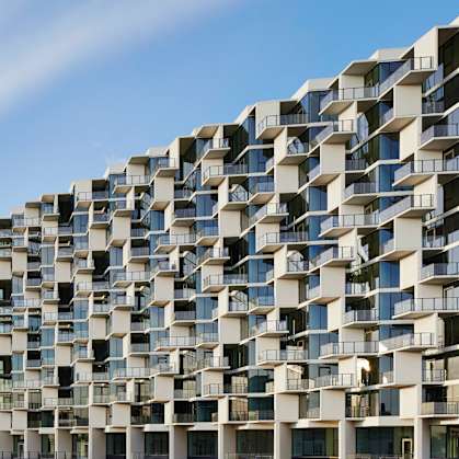 A modern building with a lot of windows and balconies.
