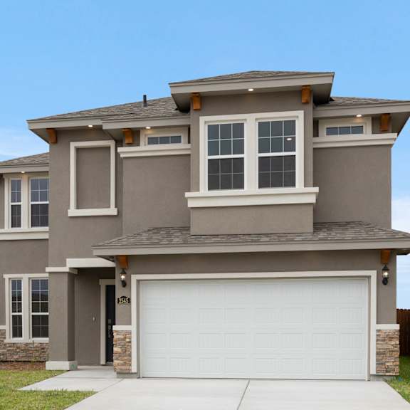 A modern house with a grey exterior and a white garage door.