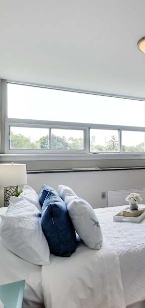 an empty bedroom with a bed and a window