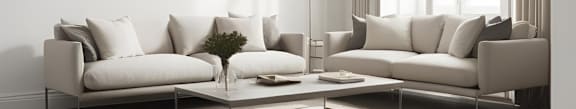A living room with a white couch and a coffee table.