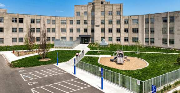 a large building with a playground in front of it