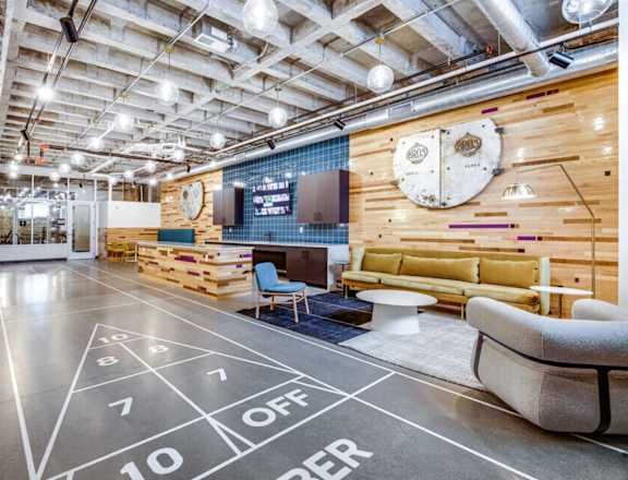a living room with a basketball court and a projector screen on the floor