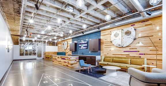 a living room with a basketball court and a projector screen on the floor