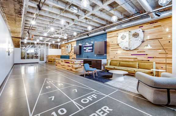 a living room with a basketball court and a projector screen on the floor