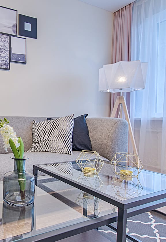 a living room with a couch and a glass table