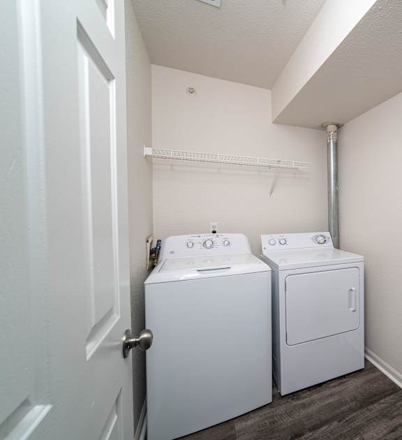 the laundry room has a washer and dryer and a boiler and water heater
