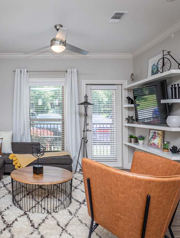 a kitchen and dining area with a table and chairs and a refrigerator at The McKenzie Park Apartments, Little Rock, 72223