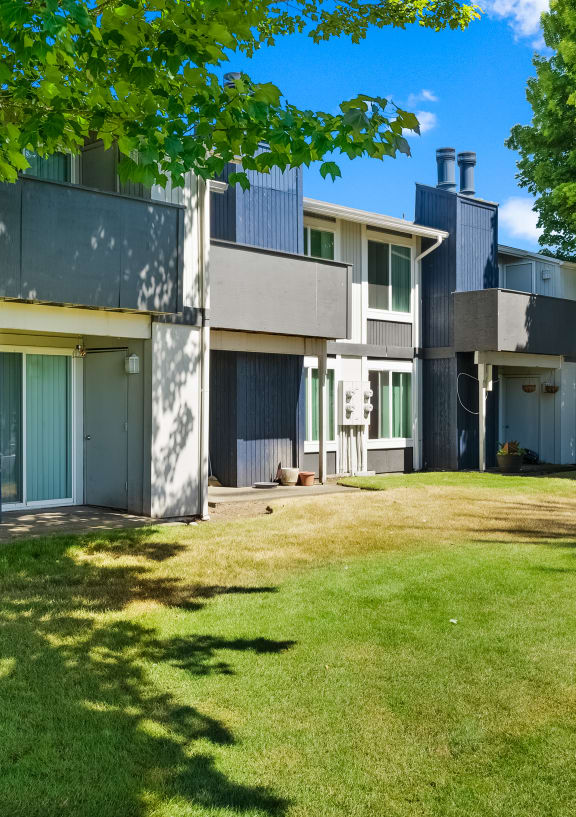 a view of a house with a yard and trees