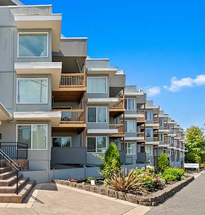 A modern apartment building with a clear blue sky above.