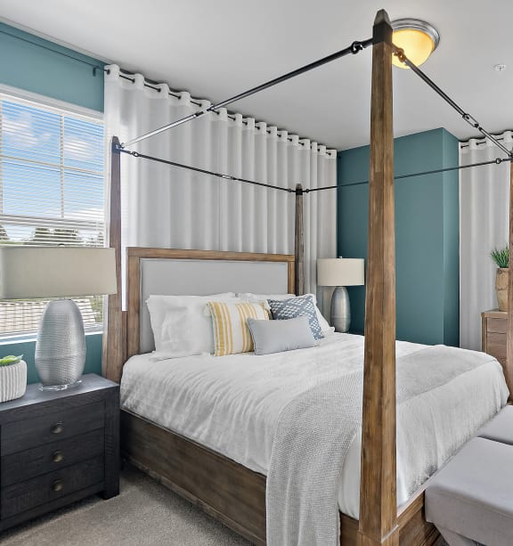a bedroom with a bed and a dresser and a window