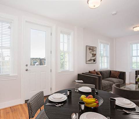 a dining room with a table and chairs and a living room