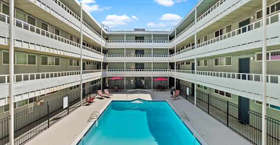 an empty pool in the middle of an apartment building