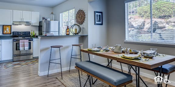 A kitchen with a table set for a meal.