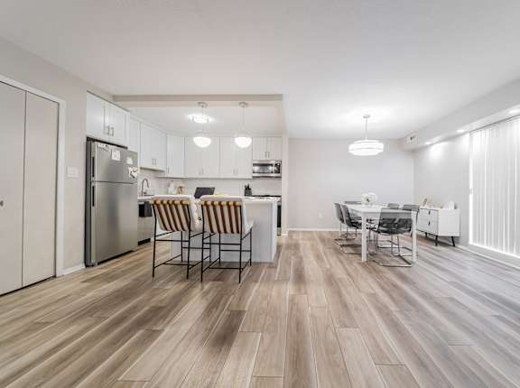 A kitchen with a dining table and chairs.