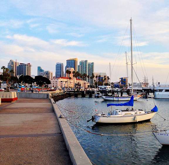 a harbor with boats and a city in the background