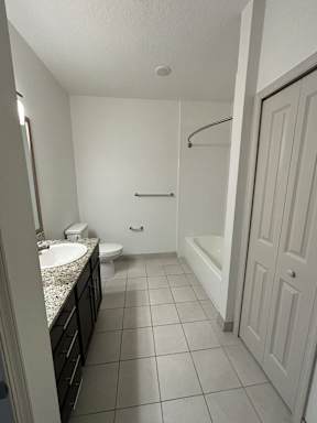 a bathroom with a sink and a toilet and a bath tub
