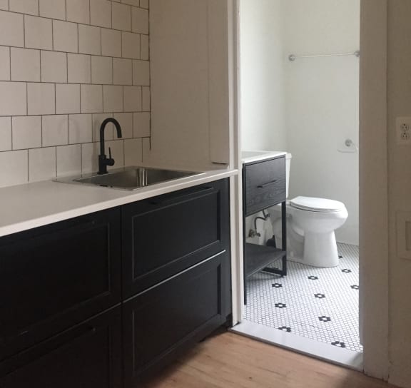 a bedroom with a bed and a door to a bathroom