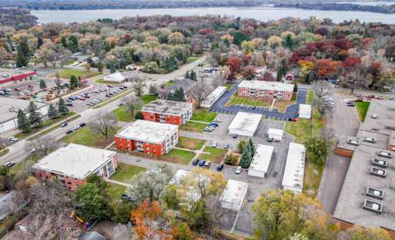 an aerial view of a city with buildings and a body of water